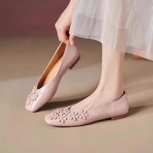 Blush Rose vegan leather square toe flats with tonal floral appliques and pearl centers, worn by a woman, showcasing the elegant slip-on style.