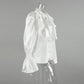Side view of the Brixen Elegant Satin Blouse in pure white, featuring dramatic front ruffles, a high stand collar, and voluminous trumpet sleeves with smocked cuffs.