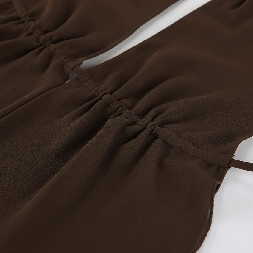 Close-up of a chocolate brown chiffon halter top, showcasing delicate ruching at the bust and a fabric tie strap detail.