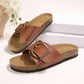 Brown PU leather slip-on slide sandals featuring an antique brass buckle and a contoured natural cork footbed, displayed as a pair.