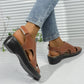 Model wearing elegant brown faux leather peep-toe wedge sandals with adjustable ankle strap and white contrast stitching, paired with denim jeans.