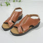 Pair of elegant brown faux leather peep-toe wedge sandals with white contrast stitching and adjustable ankle straps, shown from a three-quarter angle.