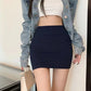 Model wearing a dark navy high-waisted bodycon mini skirt, showcasing its smooth, form-fitting silhouette and a wide waistband. Styled with a white crop top and denim jacket.