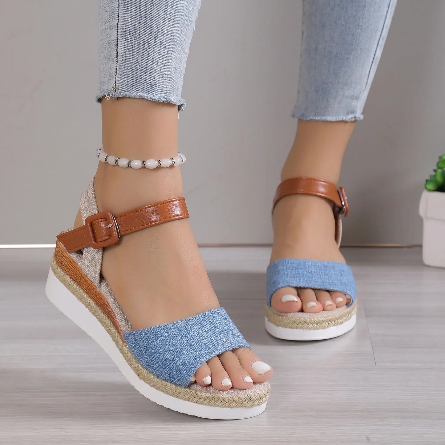 Elarae women's denim blue espadrille wedge sandals with peep-toe, adjustable tan faux leather ankle strap, and white platform sole shown on feet.