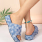 Women's distressed denim checkerboard platform slide sandals with frayed edges, shown on feet with an anklet, against a light peach seamless background.