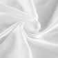 Close-up view of flowing ivory satin-like fabric with delicate folds, showcasing its subtle sheen and luxurious drape, perfect for elegant loungewear or resort wear.