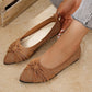 Women's elegant bronze knit pointed-toe flat shoes with a decorative bow accent, shown on a foot with subtle metallic shimmer and a matching shoe beside it.