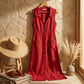 Elivora linen midi dress in sunset rose red with button-down front and pockets, displayed in a rustic coastal lifestyle setting.