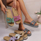 A woman's legs and feet showcasing multiple embellished platform slide sandals in various colors, including fuchsia, green, white, yellow multi, and black, against a neutral studio background.