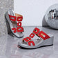 Eskari chic red platform wedge sandals with decorative geometric gold hardware and a textured metallic silver wedge heel shown from a three-quarter angle on a reflective surface with a disco ball.