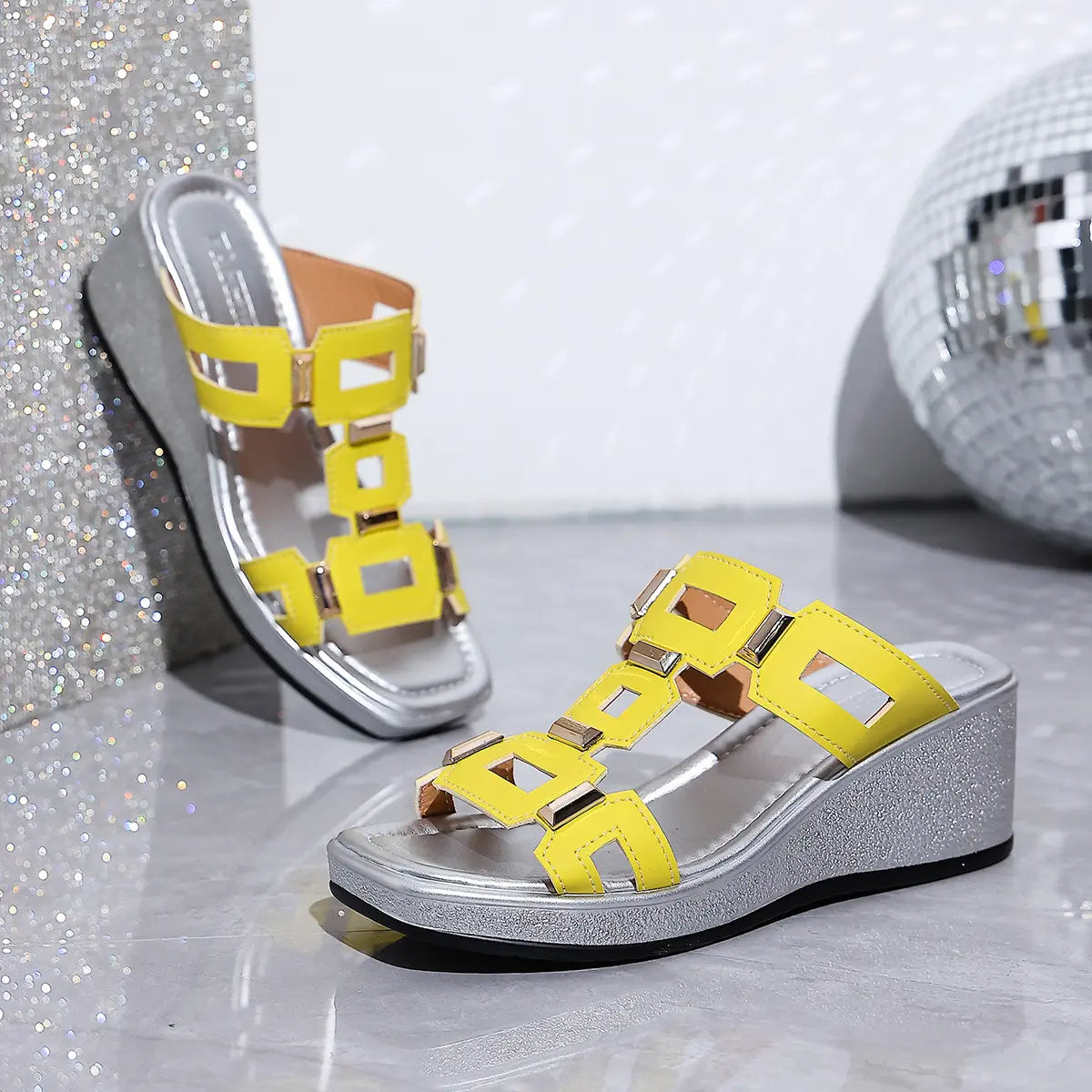 Yellow Eskari women's wedge sandals with geometric gold hardware and a textured silver metallic platform wedge and sole.