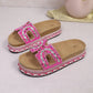 Fuchsia pink platform slide sandals featuring intricate bead and rhinestone embellishments on the straps, with a layered cork and woven midsole.