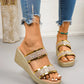 Close-up of women's gold glitter wedge slide sandals worn on a model's feet with distressed denim jeans, showcasing the open toe and textured wedge heel.