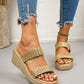 Women's metallic gold woven strap platform wedge sandals shown on feet with ripped denim jeans, featuring an open-toe slip-on design and a sculpted wedge heel.