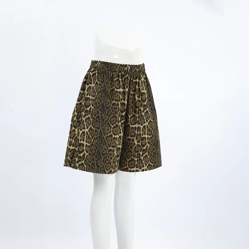 Gyzmar high-rise leopard print shorts with a relaxed wide-leg silhouette shown from the front on a white studio background.