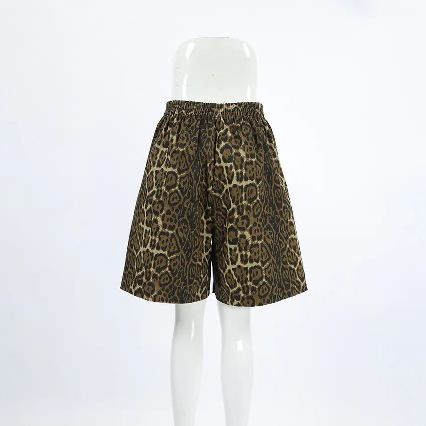 Gyzmar high-rise leopard print shorts, featuring a relaxed wide-leg silhouette and an elasticated waistband, presented front-on against a clean white studio background.