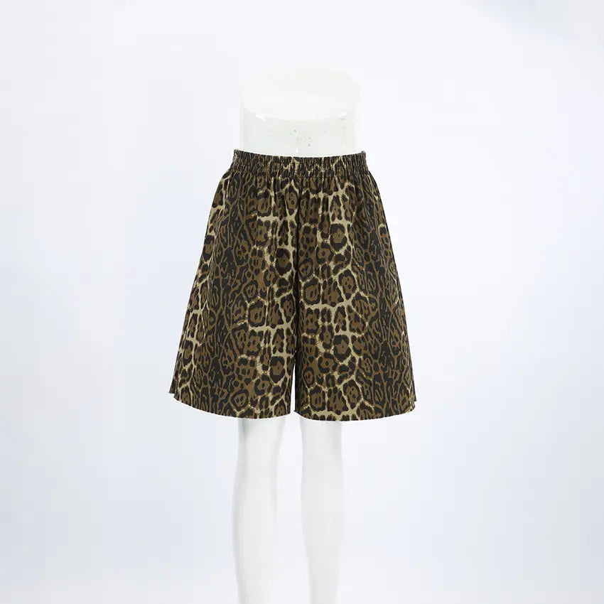 Gyzmar high-rise wide-leg leopard print shorts in warm brown and black, displayed from the front on a white studio background.