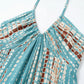 Close-up of the gathered halter neckline on the Zendru Halter Maxi Dress, showcasing the unique teal, white, and rust tie-dye print fabric.