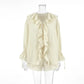 Ivory cream bohemian ruffle set featuring a V-neck tie-front blouse with balloon sleeves and high-waisted drawstring shorts, presented on a mannequin.