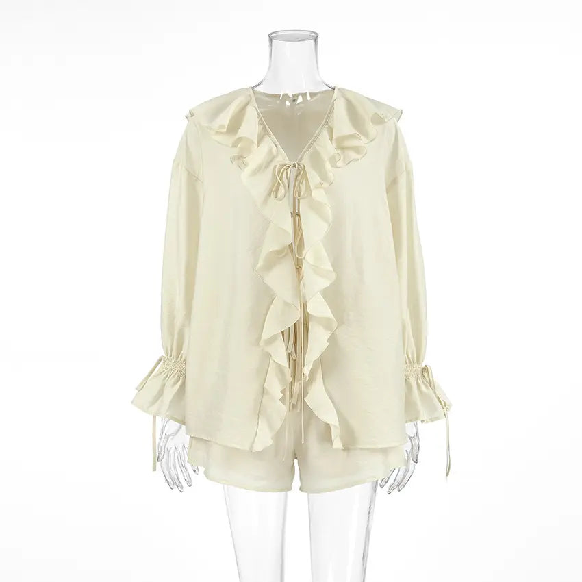 Ivory cream bohemian ruffle set featuring a V-neck tie-front blouse with balloon sleeves and high-waisted drawstring shorts, presented on a mannequin.