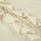 Close-up view of a cream ivory bohemian ruffle set showcasing tiered ruffles, delicate tie strings, and lightweight woven fabric texture.