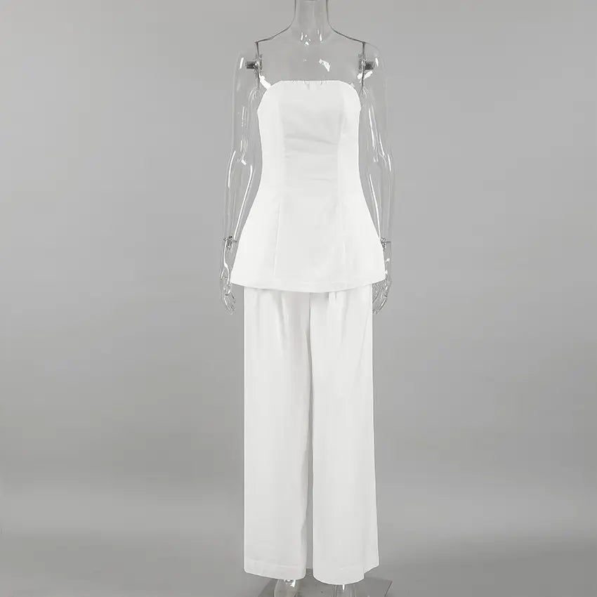 Ivory linen strapless bandeau top and wide-leg pants set displayed from the front on a mannequin against a studio background. This elegant ensemble features a flowing silhouette.