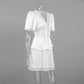 Side view of an ivory satin two-piece set featuring a V-neck blouse with delicate lace trim and puffed sleeves, paired with a lace-hem mini skirt, presented on a mannequin.