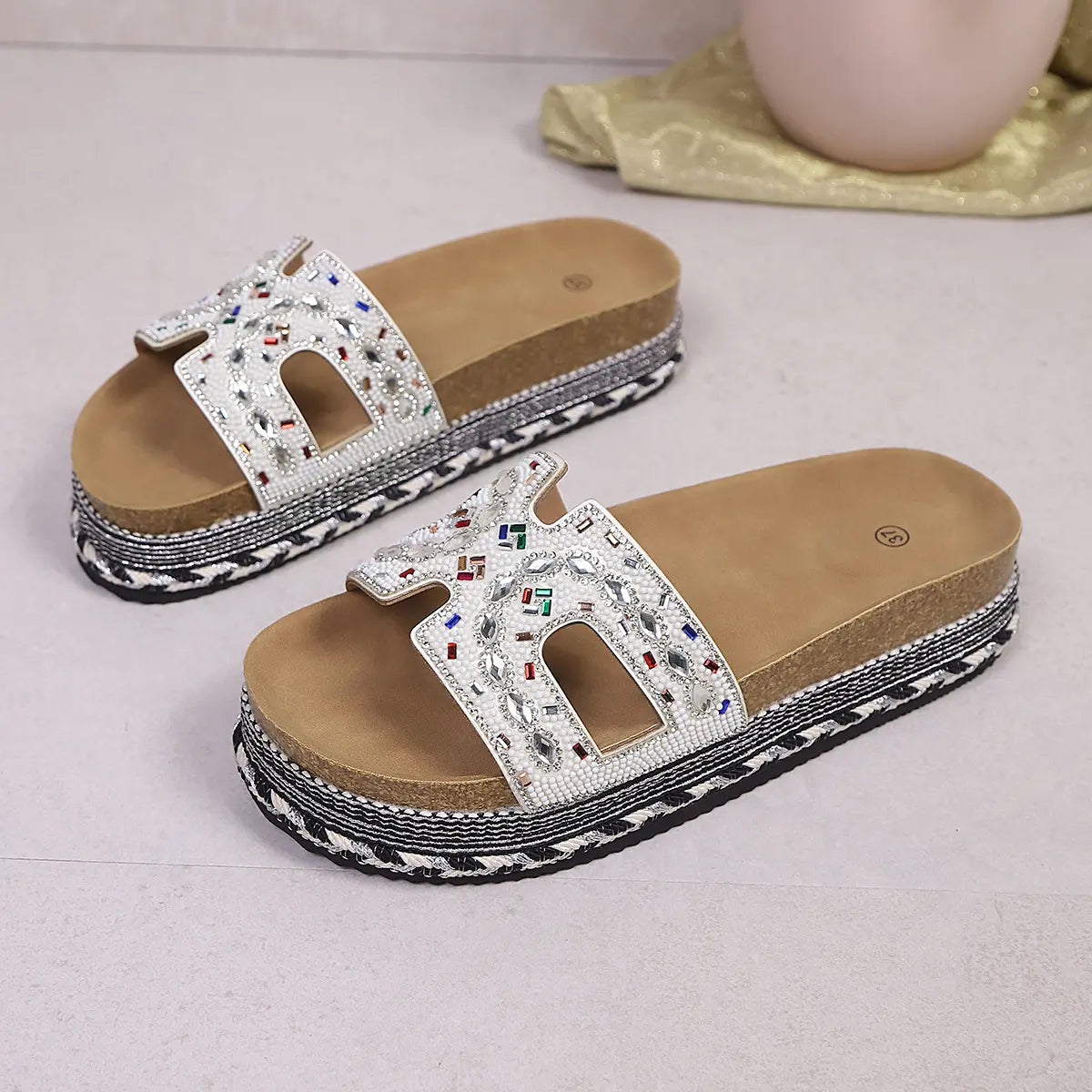 Jelani embellished platform slide sandals with U-shaped straps adorned in mixed beads and rhinestones, featuring a cork footbed and woven midsole detail.