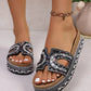 Jelani embellished platform slide sandals worn on feet, showcasing intricate bead and rhinestone detailing on the U-shaped strap, cork footbed, and woven midsole. White toenails complement the open-toe design.