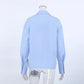 Back view of Jorvik women's powder blue collared long-sleeved blouse with a relaxed fit and button cuffs, showcasing the smooth fabric.