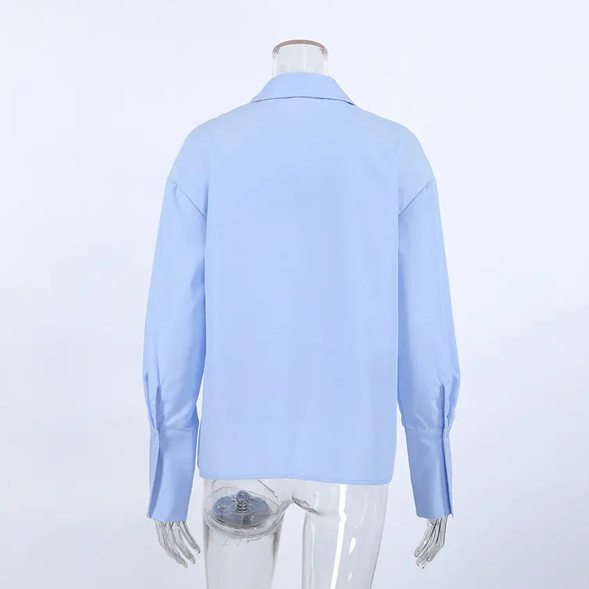 Back view of Jorvik women's powder blue collared long-sleeved blouse with a relaxed fit and button cuffs, showcasing the smooth fabric.