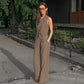 Chic beige Jovik women's vest and wide-leg trouser set worn by a model outdoors, showcasing the asymmetrical crossover vest and high-waisted pleated trousers.