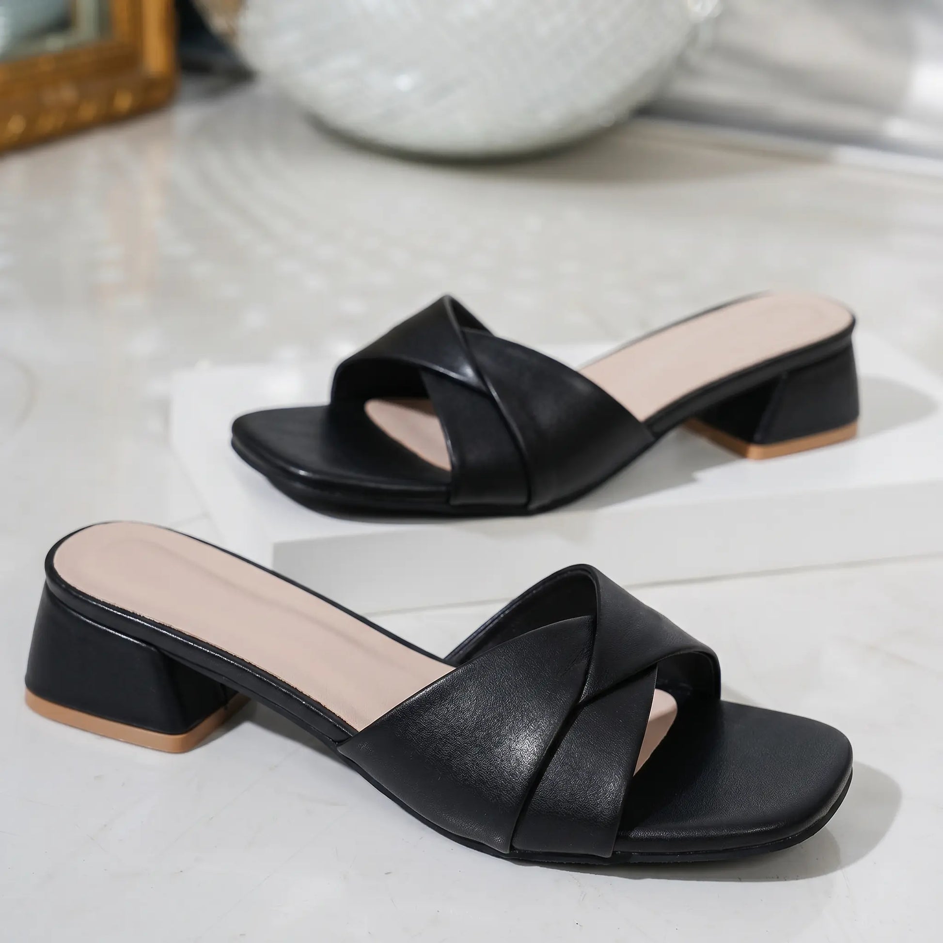 Kaelan Midnight Black PU leather slide sandals featuring a modern square toe, a twisted strap vamp, and a low 4cm block heel with a tan cap.