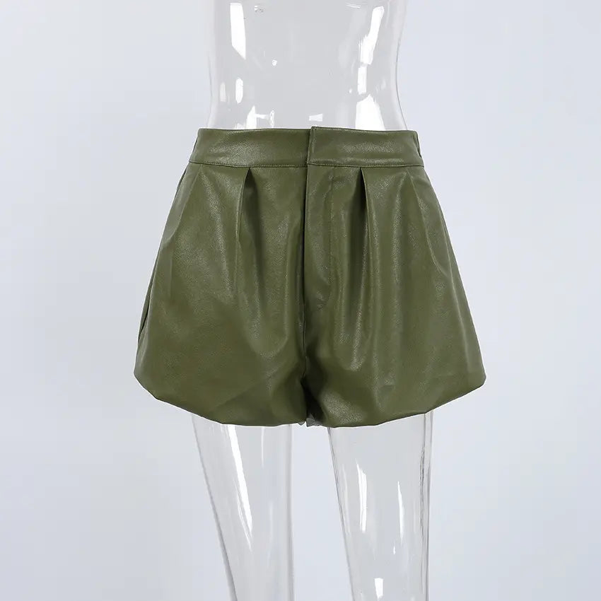 Kaelan high-waist olive green faux leather shorts with balloon silhouette and structured front pleats, presented on a mannequin from a front view.