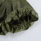 Close-up detail of olive green high-waist faux leather shorts, showcasing the gathered elasticated hem and subtle sheen of the material.