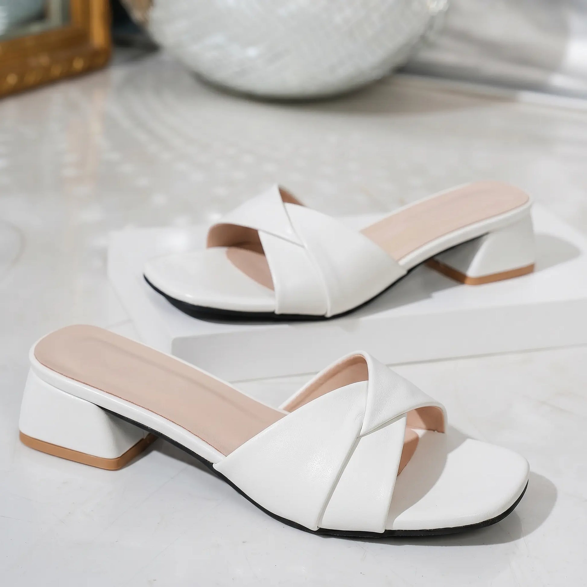 Kaelan white square toe slide sandals with a twisted strap and a 4cm block heel, featuring a blush pink insole.