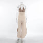 Back view of a Kaelen beige two-piece set featuring a V-neck halter vest and flowing wide-leg palazzo trousers with side splits, displayed on a mannequin against a white background.