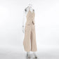 Kaelen beige two-piece ensemble featuring a V-neck halter vest and flowing wide-leg palazzo trousers, presented from a side view on a mannequin against a neutral studio background.