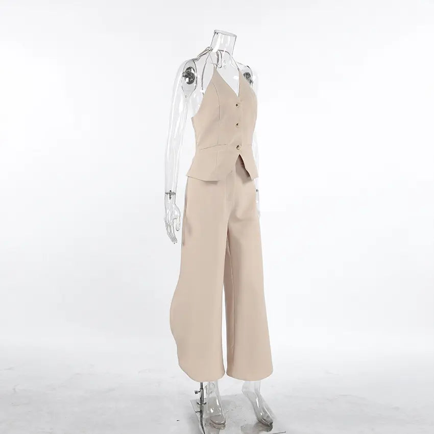 Kaelen beige two-piece ensemble featuring a V-neck halter vest and flowing wide-leg palazzo trousers, presented from a side view on a mannequin against a neutral studio background.