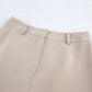 Close-up of Kaelen's beige wide-leg trousers waistband, showcasing the matte polyester-spandex blend fabric, tailored fit, belt loops, and concealed side zip detail.