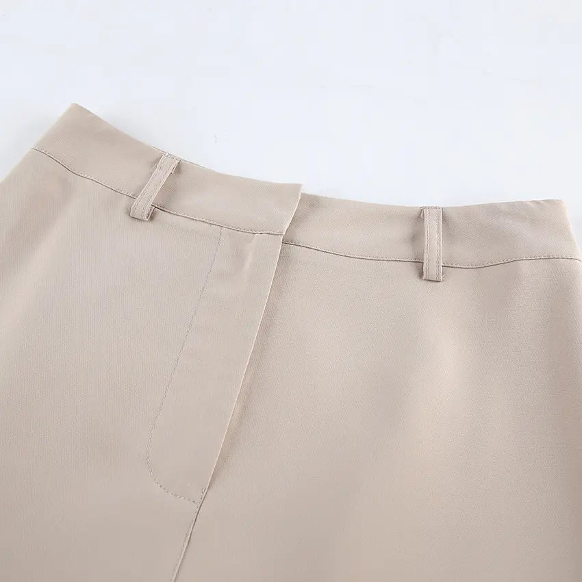 Close-up of Kaelen's beige wide-leg trousers waistband, showcasing the matte polyester-spandex blend fabric, tailored fit, belt loops, and concealed side zip detail.