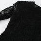 Close-up view of a black Kaelen lace mini dress, showcasing the intricate floral lace texture on the long sleeve and shoulder.