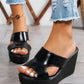 Black Kaelen elegant wedge sandals with peep-toe design and single PU strap, styled with ripped denim jeans on a model's feet.
