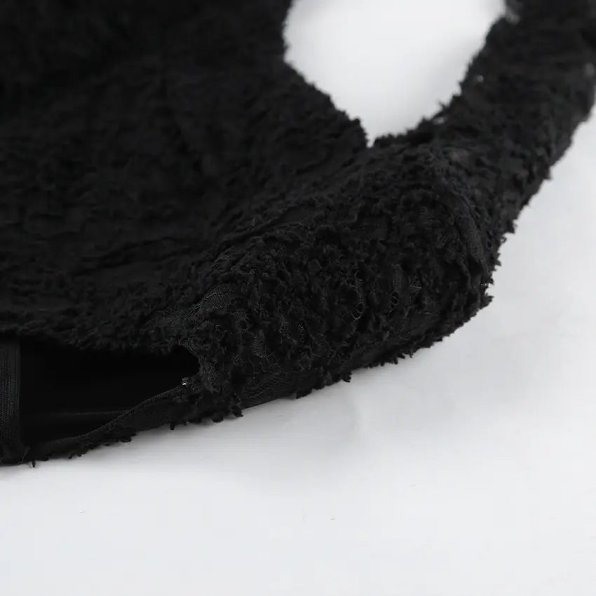 Close-up of black floral lace fabric on the Kaelen Elegant Lace Mini Dress, showcasing its intricate openwork texture and delicate details.