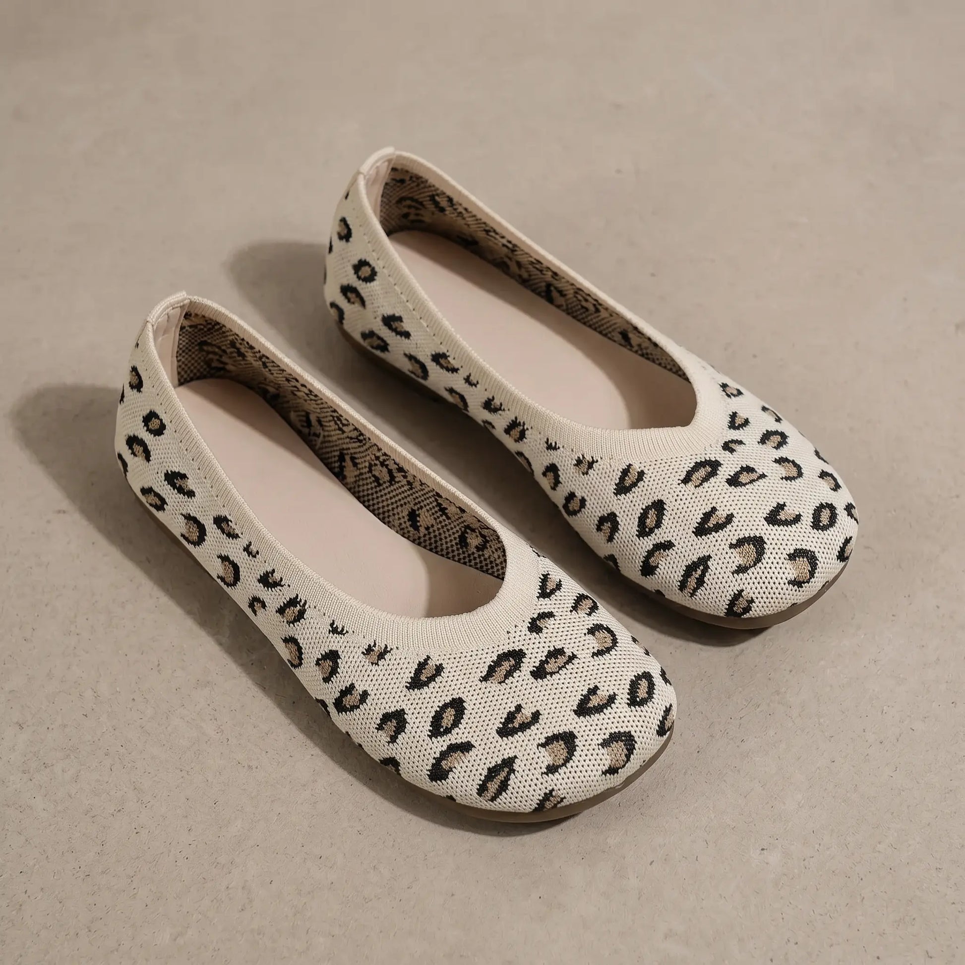 A pair of Kaelen women's slip-on ballet flats in classic leopard print knit, presented from a three-quarter angle on a neutral studio surface.