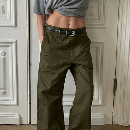 High-rise, olive green wide-leg utility trousers on a model, featuring a relaxed straight leg, zip-fly with button closure, and large front patch pockets.