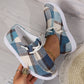 Kaelen women's comfortable plaid canvas loafers worn on feet, showing a blue, beige, and brown plaid pattern with white laces and flat white rubber soles, styled casually with a gold anklet.