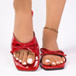 Front view of Kaelen red patent leather bow flat sandals with an open square toe, showcasing glossy material and elegant bow embellishment.