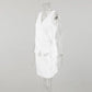 Side view of a white sleeveless wrap top and A-line mini skirt set on a mannequin, showcasing the asymmetrical tie detail and linen-blend texture.