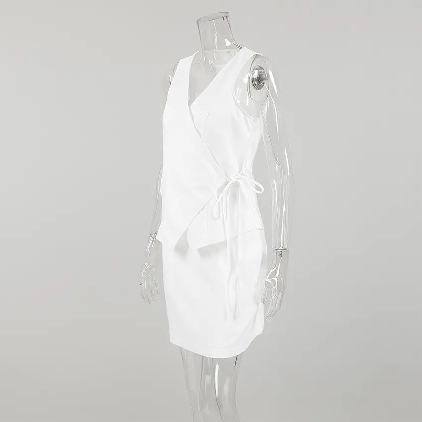 Side view of a white sleeveless wrap top and A-line mini skirt set on a mannequin, showcasing the asymmetrical tie detail and linen-blend texture.